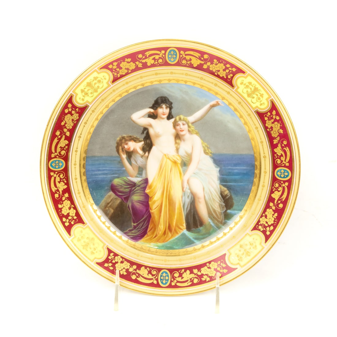 A Vienna porcelain mythological cabinet plate: A Vienna porcelain mythological cabinet plate, late 19th/early 20th century, depicting three beauties on an ocean rock, titled 'Siren', underglaze blue shield mark, 9.5"dia. Provenance: Property from 