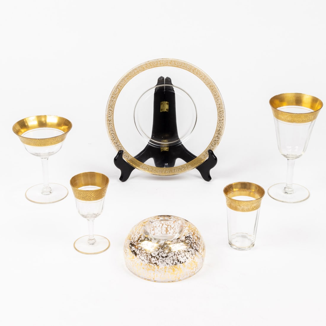 A suite of optic glass stemware with tooled gilt rims: A suite of optic glass stemware with tooled gilt rims, probably Tiffin, comprising (12) large wine glasses, 6.75"h; (12) aperitifs/cordials, 4.5"h; (11) champagne flutes, 6.5"h; (12) champagne coupes,
