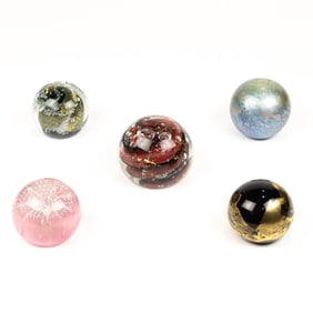 Five glass paperweights including Nourot