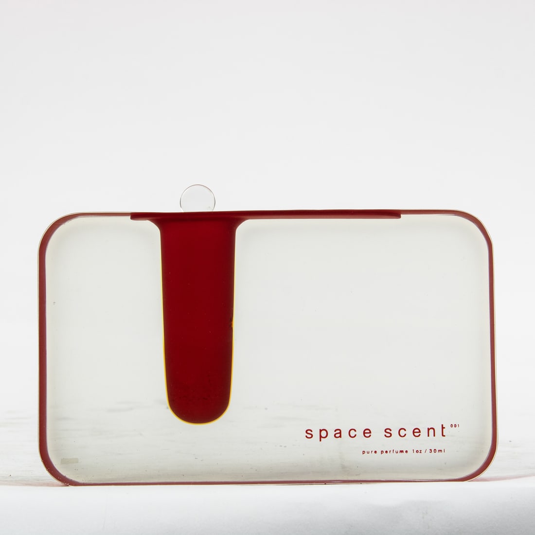 A limited edition Space Scent lucite perfurme bottle with red enameled sides (1 of 3)
