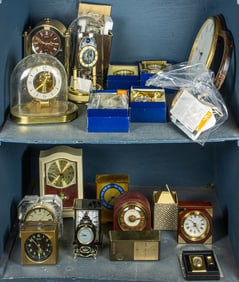 A large collection of approximately twenty clocks