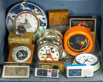 A group of fourteen vintage clocks, including Lurus Mikey Mouse, Seiko and others