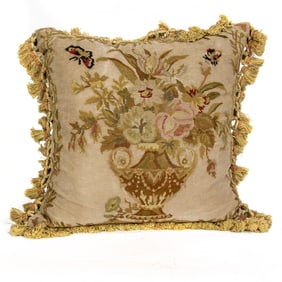 A Continental needlepoint throw pillow with tasseled fringe
