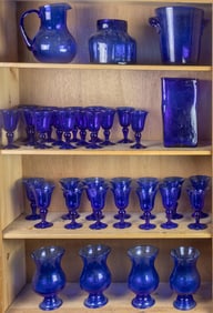 A cobalt seeded glass suite of stemware and other serving pieces