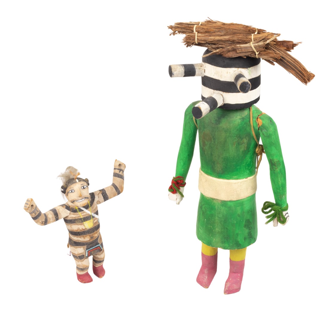 Two Hopi Clown kachinas: Two Hopi Clown kachinas, the larger with a green painted body and wearing a bundle of 'wood' on head, 17.5"h, the smaller with spread out arms, 8"h