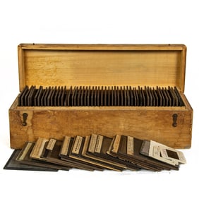A collection of approximately 100 glass lantern slides in fitted wood case