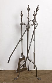A set of silvered fireplace tools