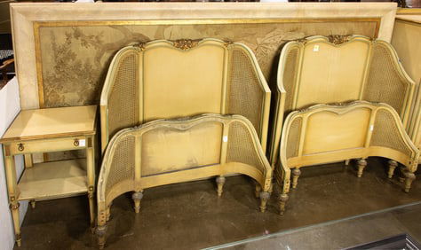 A pair Louis XVI style gilt and polychrome painted wood and caned twin beds
