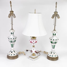 A pair and single Czechoslovakian cased cut to clear glass table lamps