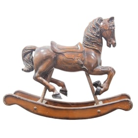 A vintage carved wood child's rocking horse