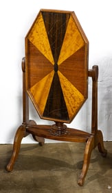 An Art Deco mixed wood veneered tilt top table with a fan inlaid hexagonal top