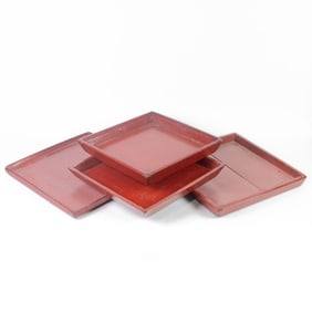 A set of four stacked Asian lacquered square trays