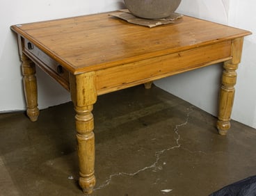 A vintage English pine table rising on turned supports