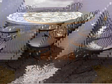 A set of six painted iron garden chairs with vinyl upholstered seats