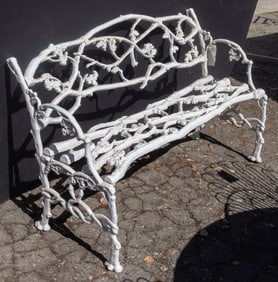 An American painted cast iron garden bench