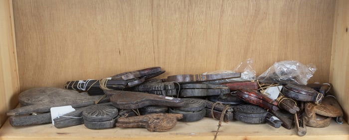Shelf of Burmese hand-held balance scale sets with original wooden cases