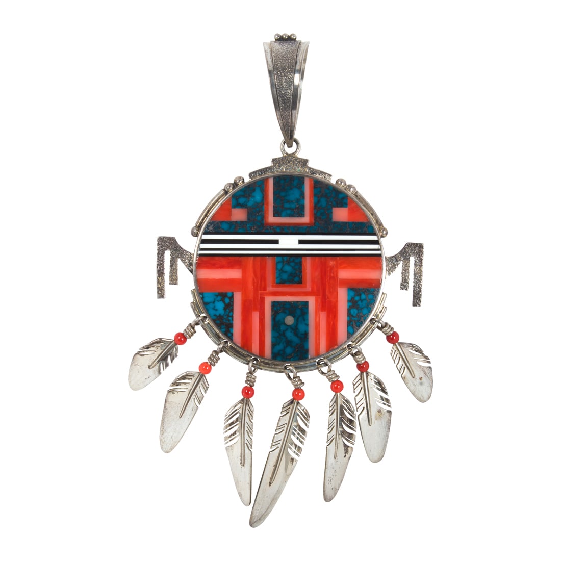 Ray Tracy, A Native American turquoise, coral and hardstone pendant: Ray Tracy, A Native American turquoise, coral and hardstone pendant inlaid to the front and back with coral, turquoise and hardstone, suspending 8 feathers; 83.45 grams; length: 5 in