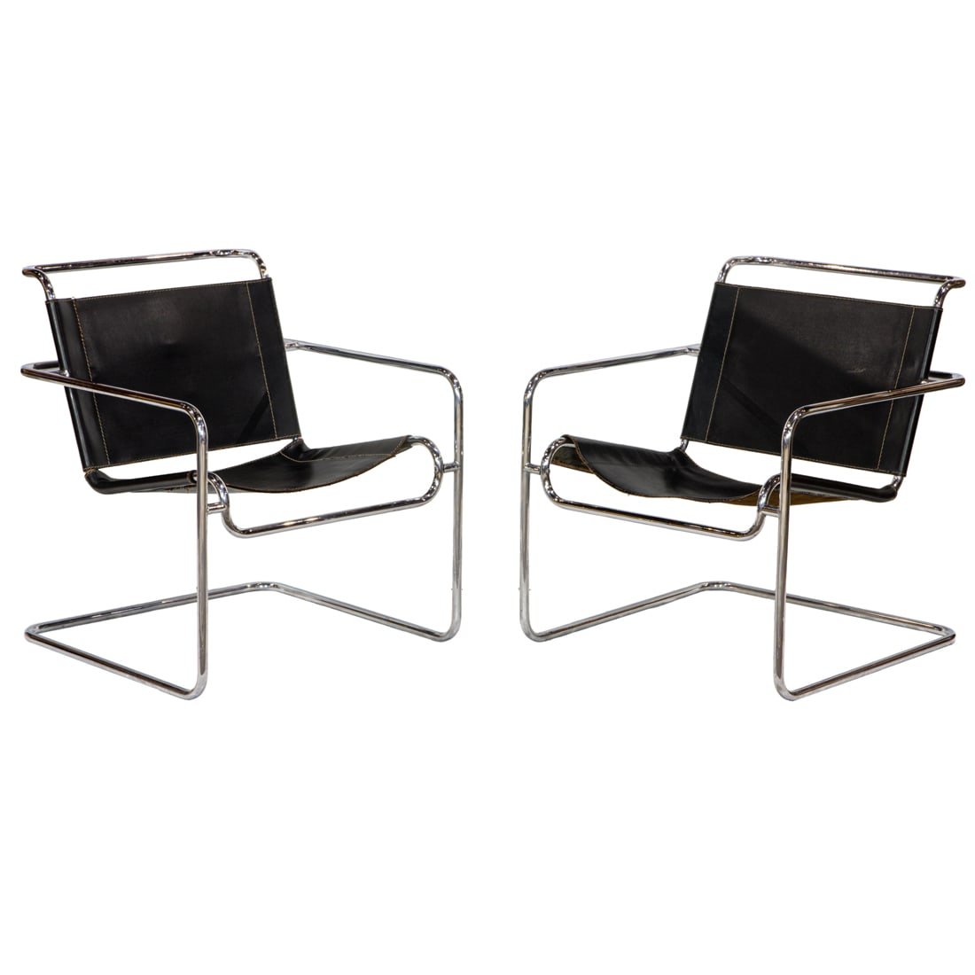 A pair of Italian Mies Van der Rohe style tubular chromed steel armchairs: A pair of Italian Mies Van der Rohe style tubular chromed steel armchairs with black leather upholstery, 29.5"d x 25.5"w x 26"d