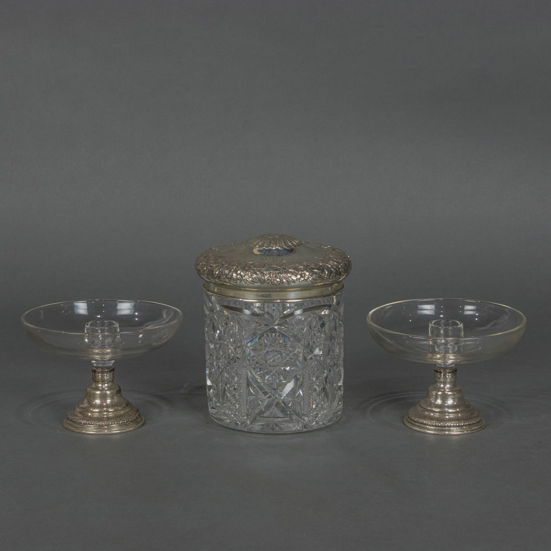 An Art Nouveau sterling floral repousse lidded cut glass cigar box; en suite with a pair of glass (1 of 2)