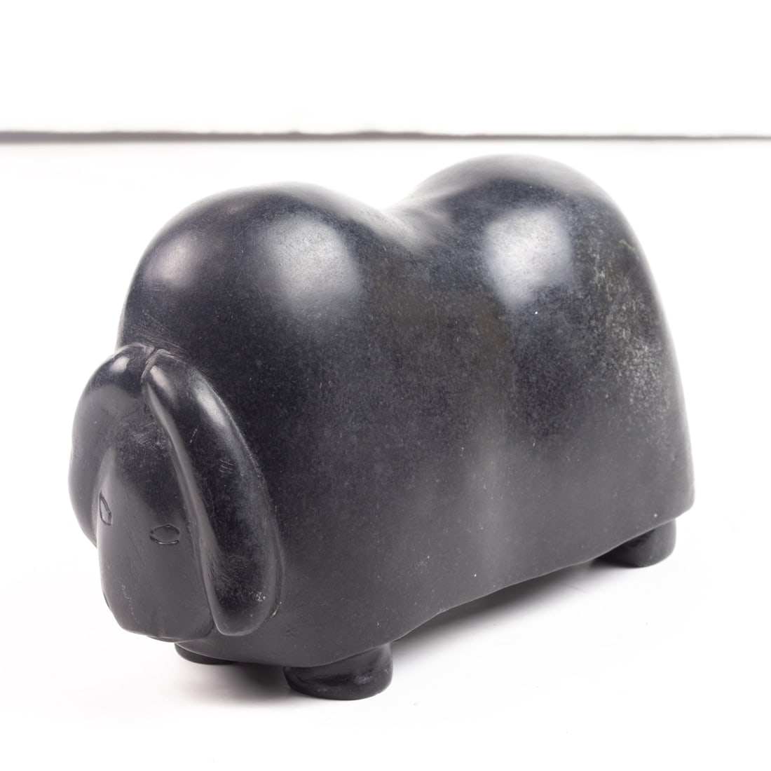An Inuit carved stone musk ox: An Inuit carved stone musk ox, unsigned, 4.25"h x 7"l