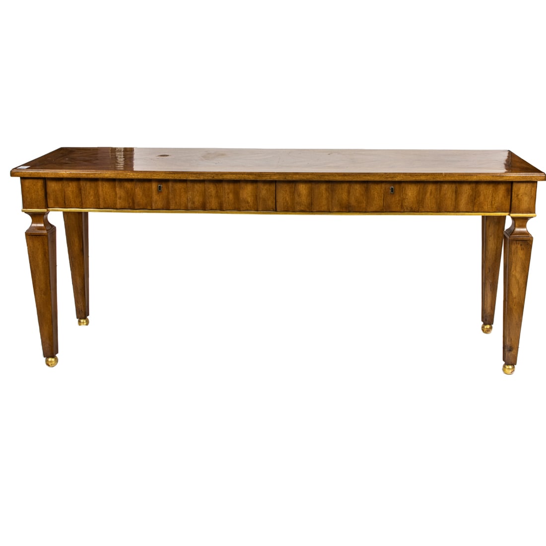 A pair of Therien Studios console tables: A contemporary pair of Therien Studios walnut console tables, fashioned in the Neoclassical taste, each outset inlaid top above a recessed fluted frieze, rising on tapered block legs atop parcel gilt