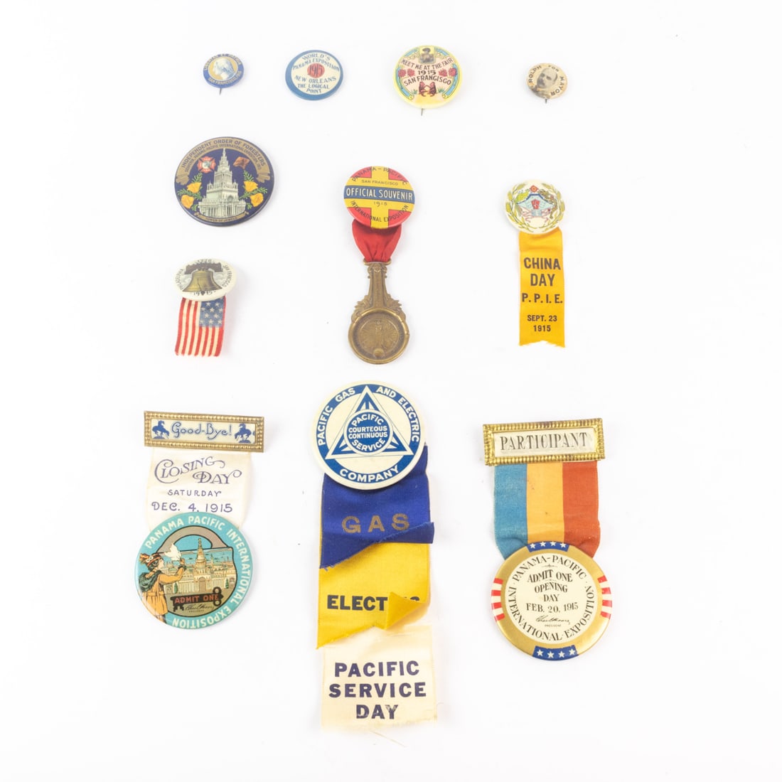 Ten celluloid pins for the 1915 Panama-Pacific International Exposition (PPIE), including 'Opening (1 of 11)