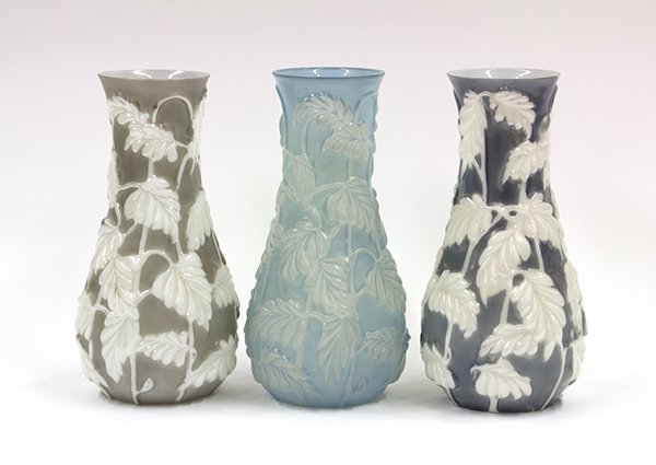 Phoenix Art Glass: (lot of 3) Phoenix art glass tapered bulbous vases in the Philodendron pattern, two having lustre pattern details on a grey ground, together with a frosted light blue finish, 11''h. Provenance: Proper