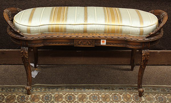 Neoclassical style window bench: Neoclassical style window bench, of kidney form, the upholstered seat centered with bow and garland accents surmounting the conforming apron and rising on cabriole legs, 22''h x 43''w x 17''d