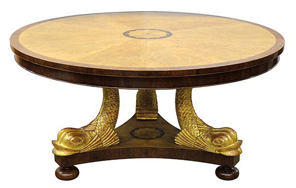 Regency style dining table: Regency style inlaid and partial gilt dining table circa 1900, the circular maple burl top centered with a starburst medallion radiating to the organic banding surmounting the gilt fish form supports