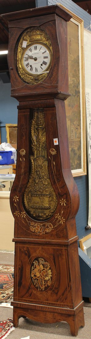 French Provincial style tall case clock: French Provincial style tall case clock, France 19th century, the faux grain painted case accented with floral sprays surrounding the two windows holding the original movement surmounted with the repo