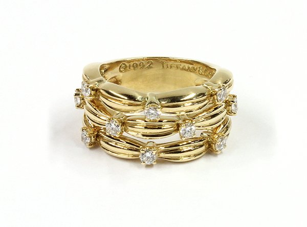Tiffany yellow gold diamond band ring: Tiffany & Co. diamond ring; mounted in 18K yellow gold, (stamped ''Copyright 1992'', ''Tiffany & Co.'', ''750''), set with (10) round full cut diamonds weighing in total 0.50 ct. (displaying: G color,