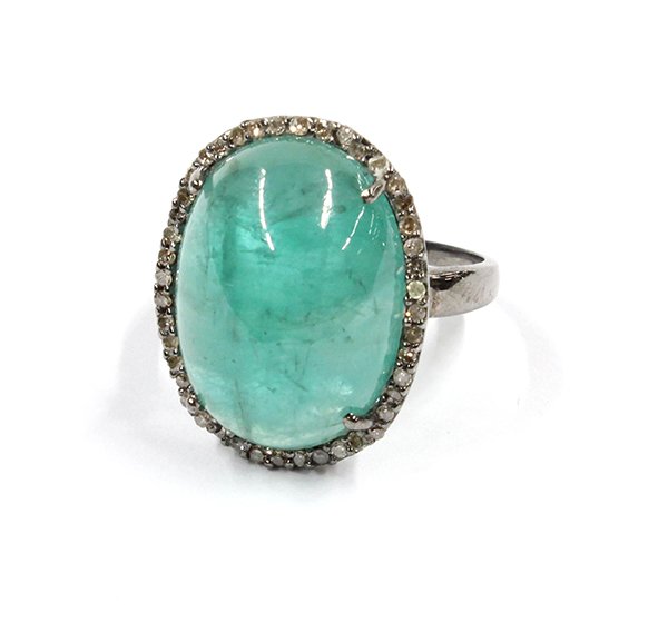 Silver, emerald and diamond ring: Lady's emerald and diamond ring; mounted in sterling silver and center 4-prong set with (1) oval cabochon cut emerald, 14.50 ct., surrounded by (44) single cut round diamonds, total weight 0.26 ct. Ri