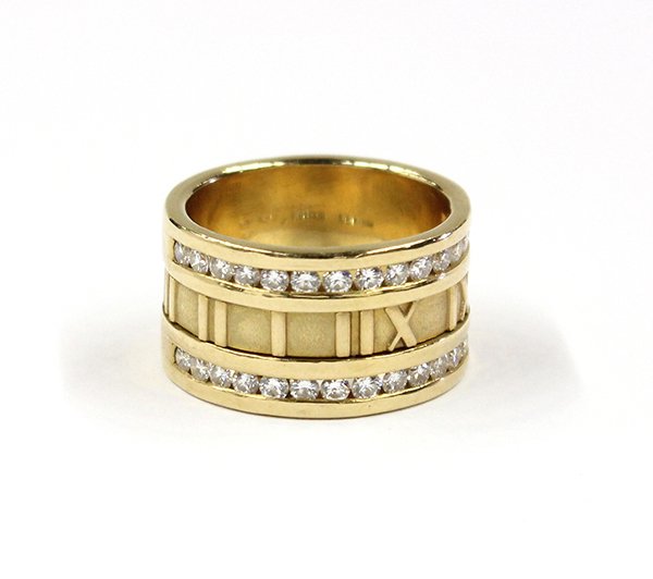 Tiffany yellow gold Atlas diamond ring: Tiffany & Co. ''Atlas'' diamond band ring; mounted in 18K yellow gold, having (30) full cut round diamonds weighing in total 0.90 ct. Total ring weight 15.8 grams. Ring is 11.81 mm wide and is a size 