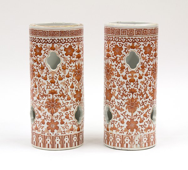 Chinese Iron-red Hat Stands, Lotus/Gourd: Pair of Chinese iron red enameled porcelain hat stands, each of the cylindrical bodies pierced with lobed openings and painted with lotus blossoms and vines issuing small double gourds all set below a