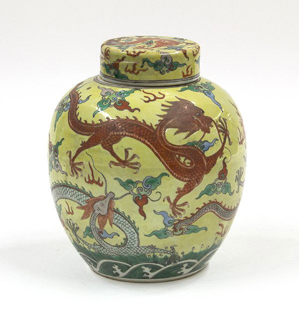 Chinese Enameled Porcelain Jar, Dragons: Chinese polychrome enamel decorated porcelain jar, the ovoid body featuring four dynamic dragons scrolling through the yellow sky accented with colored clouds above rolling waves, the recessed base ma