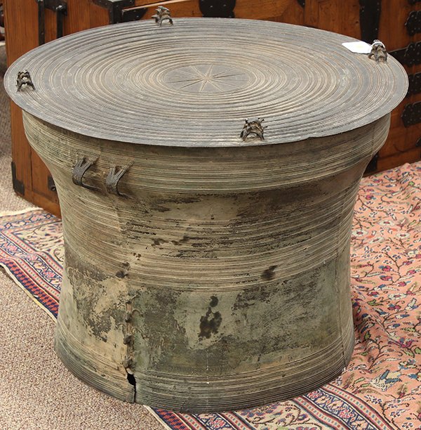 Southeast Asian Rain Drum: Southeast Asian bronze rain drum, the separately cast top with a starburst medallion encircled with concentric bands bounding geometric and zoomorphic patterns, further surmounted with four groups of 