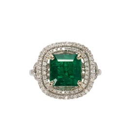 An emerald, diamond and 14k white gold ring