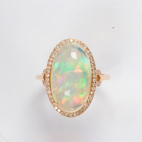 An opal, diamond, and 18k gold ring