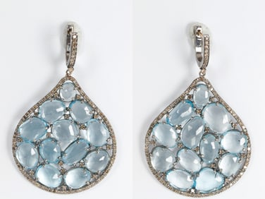 A pair of 14k blue topaz, diamond, and silver chandelier earrings