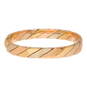 An 18k tri-color gold bangle bracelet