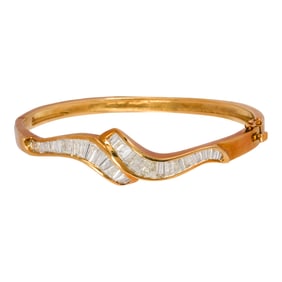 A diamond and 14k gold bangle bracelet