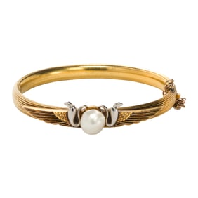 A pearl and 14 karat gold bangle bracelet