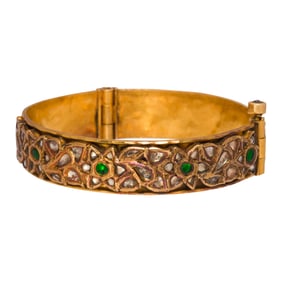 An Indian diamond, emerald and high karat gold bangle bracelet
