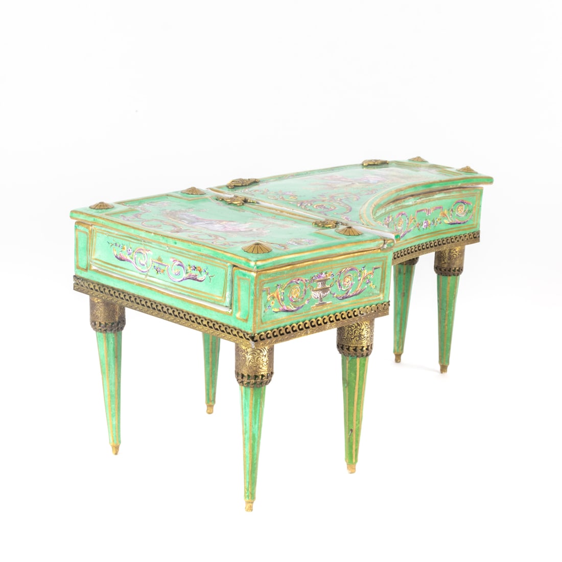 A French gilt bronze mounted porcelain piano form table box: A French gilt bronze mounted porcelain piano form table box, 19th century with later base mounts, painted with figural vignettes within scrolled frame on a green ground, the interior painted with scat