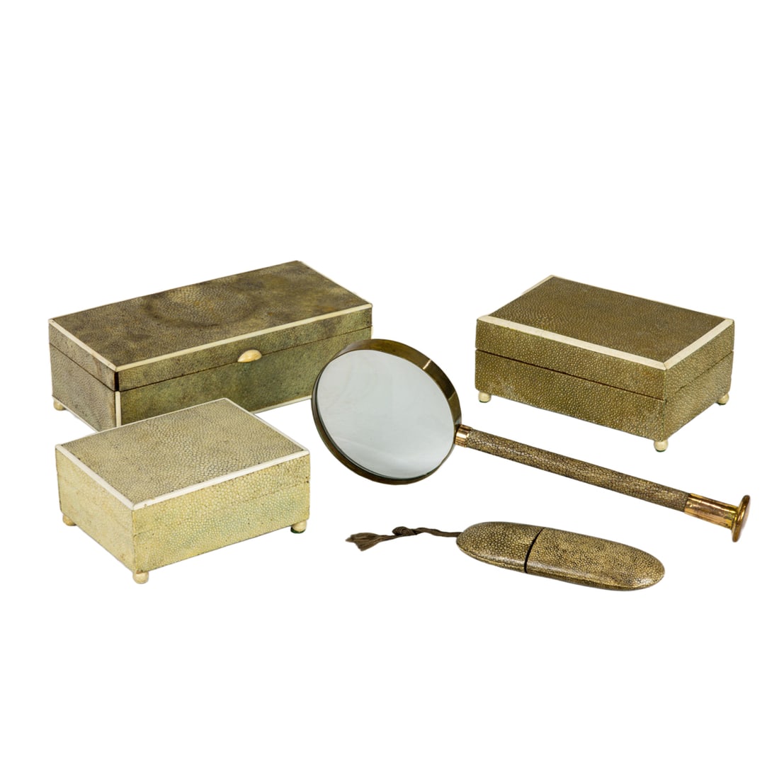 Three Continental shagreen boxes and magnifying glass: Three Continental shagreen boxes, each of rectangular form with ivory banded lids and rising on ball feet, the largest 2.75"h x 8.25"x 4"; en suite with a long shagreen wrapped and gilt handled magnif