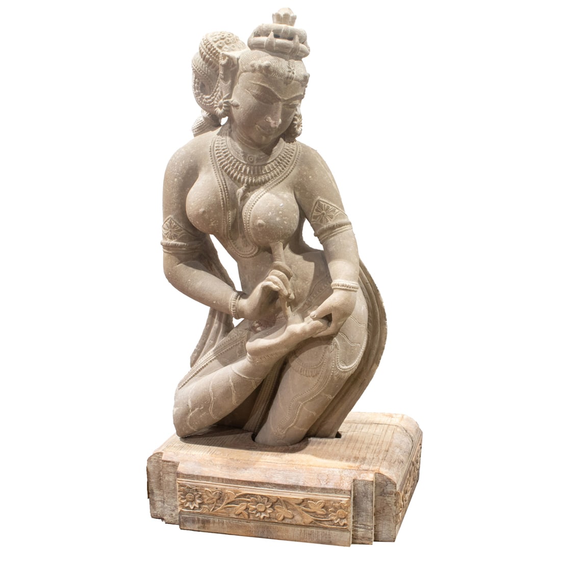 Indian sandstone carving of Devi: Indian sandstone carving of Devi. The Hinda goddess is set in a wood stand, 38"h x 14"w.