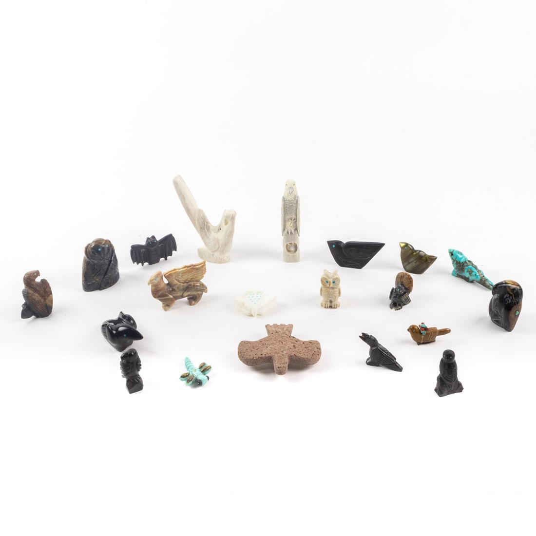 A lot of tweny Zuni fetishes of various birds, carved of stone, bone and jet, including eagles, a: A lot of twenty Zuni fetishes of various birds, carved of stone, bone and jet, including eagles, a bat, and owls, many signed, the largest 4"h
