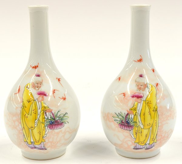 Two Chinese Small Stick Neck Vases, Shoulao: Pair of Chinese small porcelain stick neck vases, each with a slender neck above a pear shaped body, decorated with Shoulao holding a lingzhi and a flower basket, while five red bats soar, reversed wi