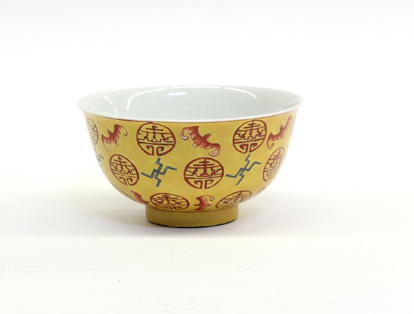 Chinese Porcelain Bowl, Bats and Shou: Chinese enameled porcelain yellow ground bowl, the exterior featuring auspicious bats and red shou medallions along with blue wanzi emblems on a yellow ground, the recessed base with an apocryphal red