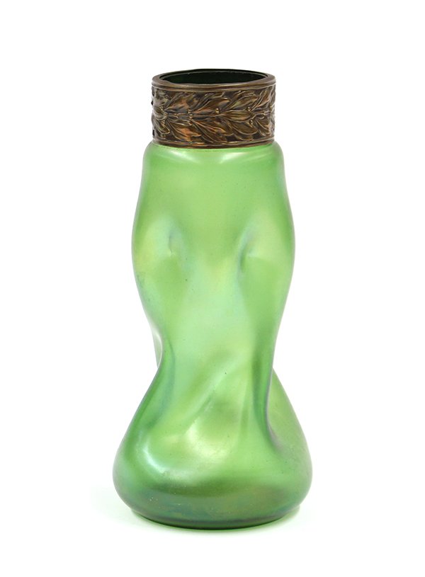Iridescent art glass vase: Iridescent art glass vase attributed to Loetz, the emerald iridescent form having a pinched and shaped body surmounted with a floral decorated patinated metal cuff and rising on a circular base, 9.5''